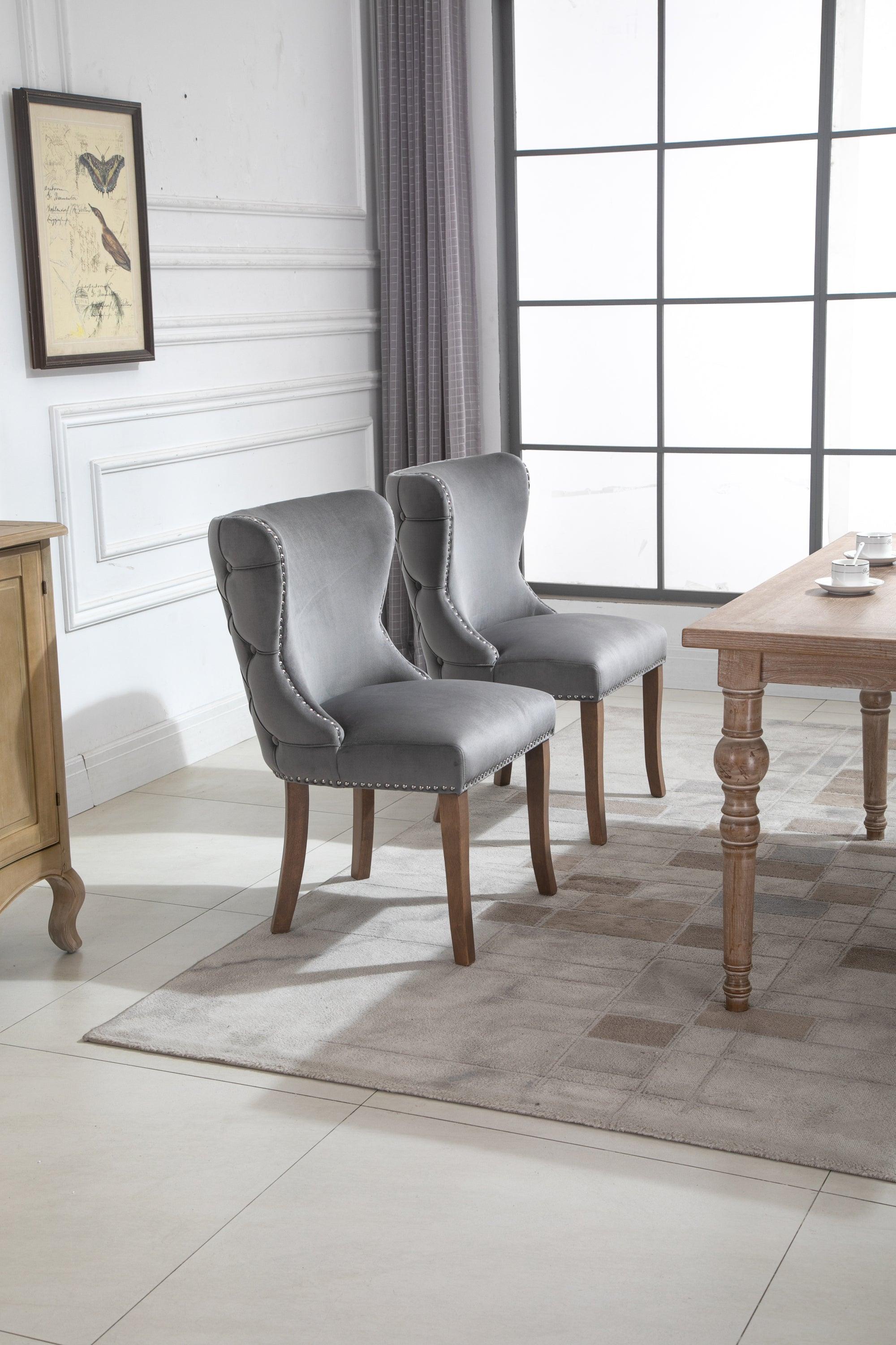 Set of 2 upholstered wing-back dining chair with backstitching nailhead trim and solid wood legs